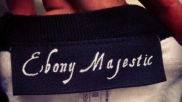 Woven custom clothing label sewn into a t-shirt neckline.