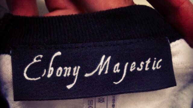 Woven custom clothing label sewn into a t-shirt neckline.